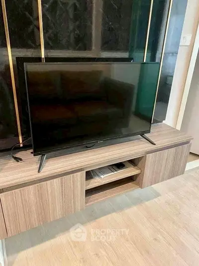 Modern living room with sleek TV stand and flat-screen television