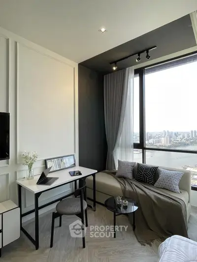 Modern living room with stunning city view, cozy sofa, and stylish decor in high-rise apartment.