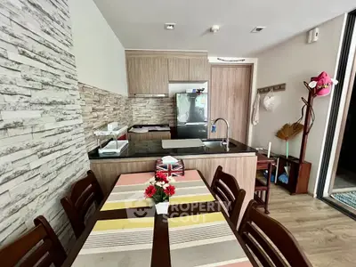 Charming kitchen with modern appliances and stylish dining area in cozy apartment.