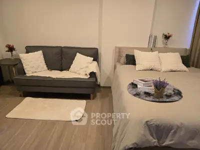Cozy bedroom with a stylish sofa and elegant decor, perfect for relaxation and comfort.