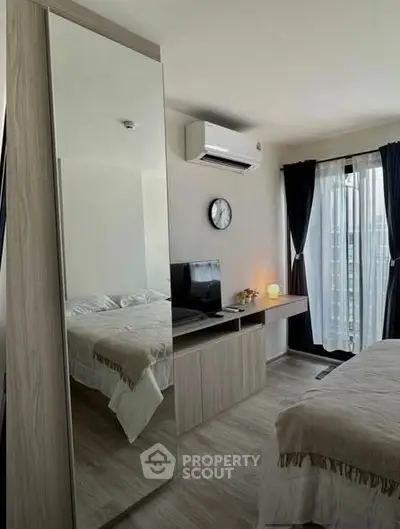 Modern bedroom with mirrored wardrobe and natural light