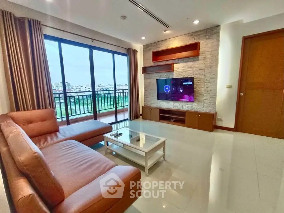 Spacious living room with modern decor and large windows offering a stunning view.