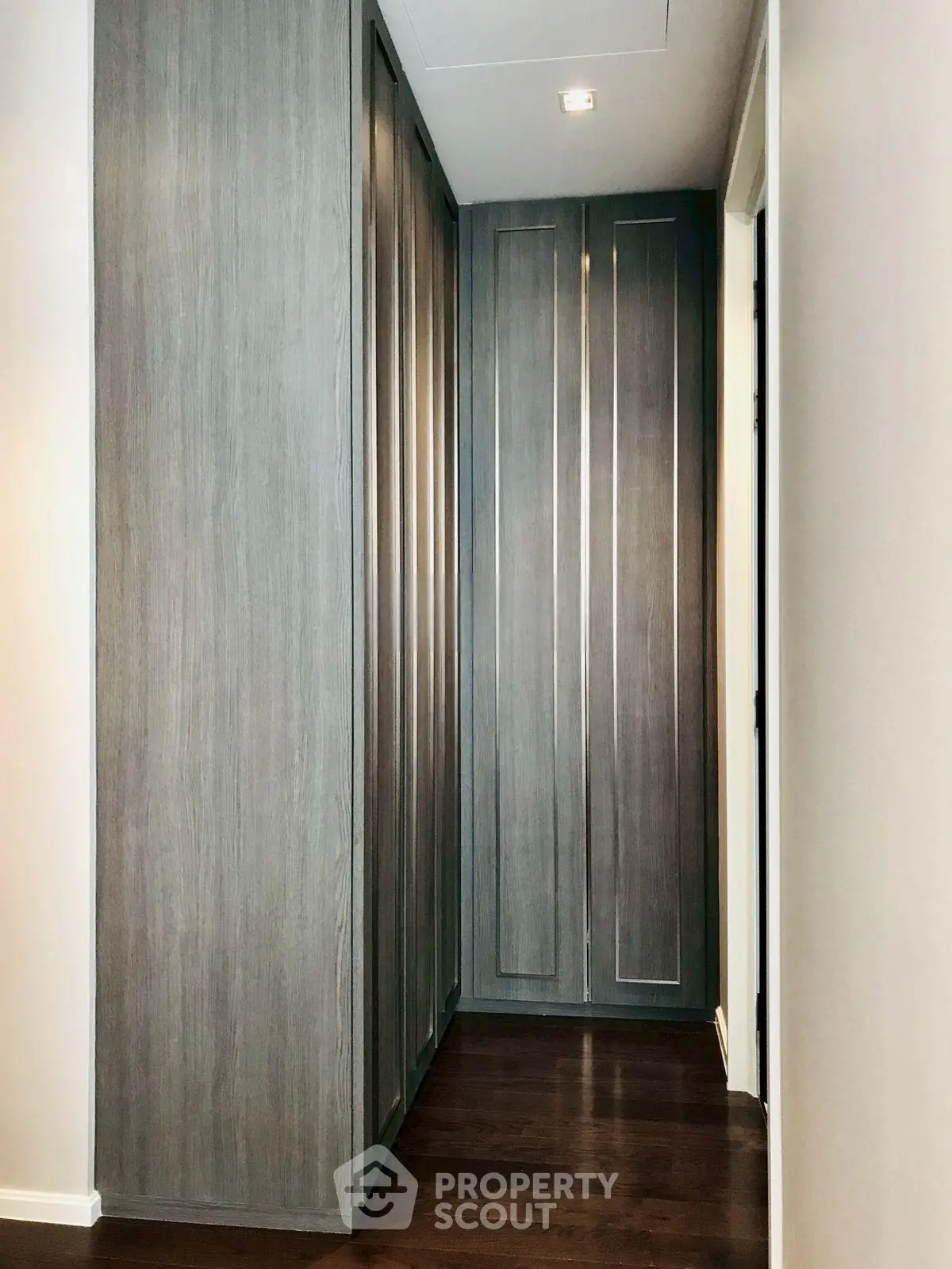 Elegant hallway with sleek wooden storage cabinets and modern lighting