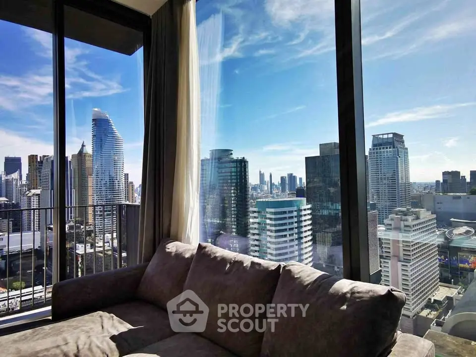 Luxurious living room with stunning city skyline view from high-rise apartment.