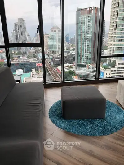Stunning high-rise living room with panoramic city views and modern decor.