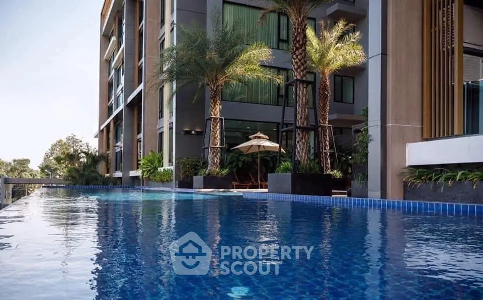 Luxurious apartment complex with stunning pool and palm trees