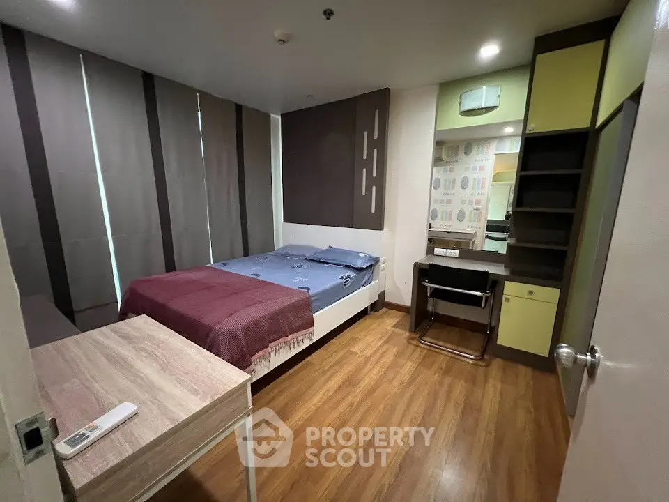 Modern bedroom with wooden flooring and stylish decor