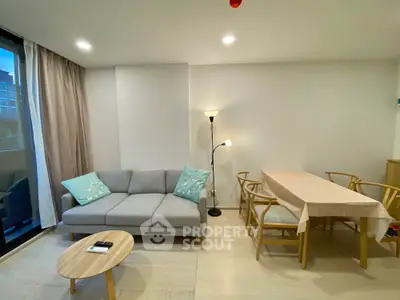 Modern living room with cozy sofa and dining area in stylish apartment