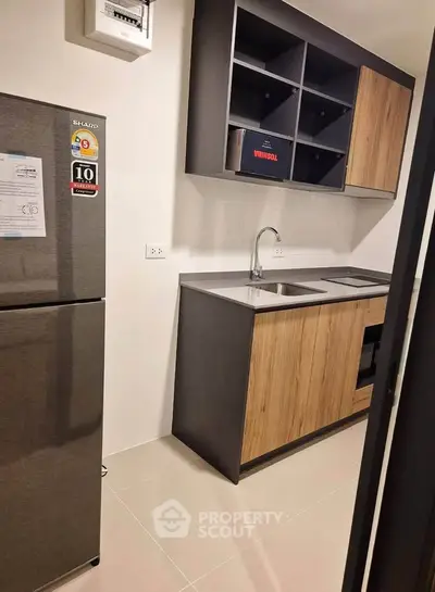 Modern kitchen with sleek cabinets and stainless steel appliances in a compact layout.