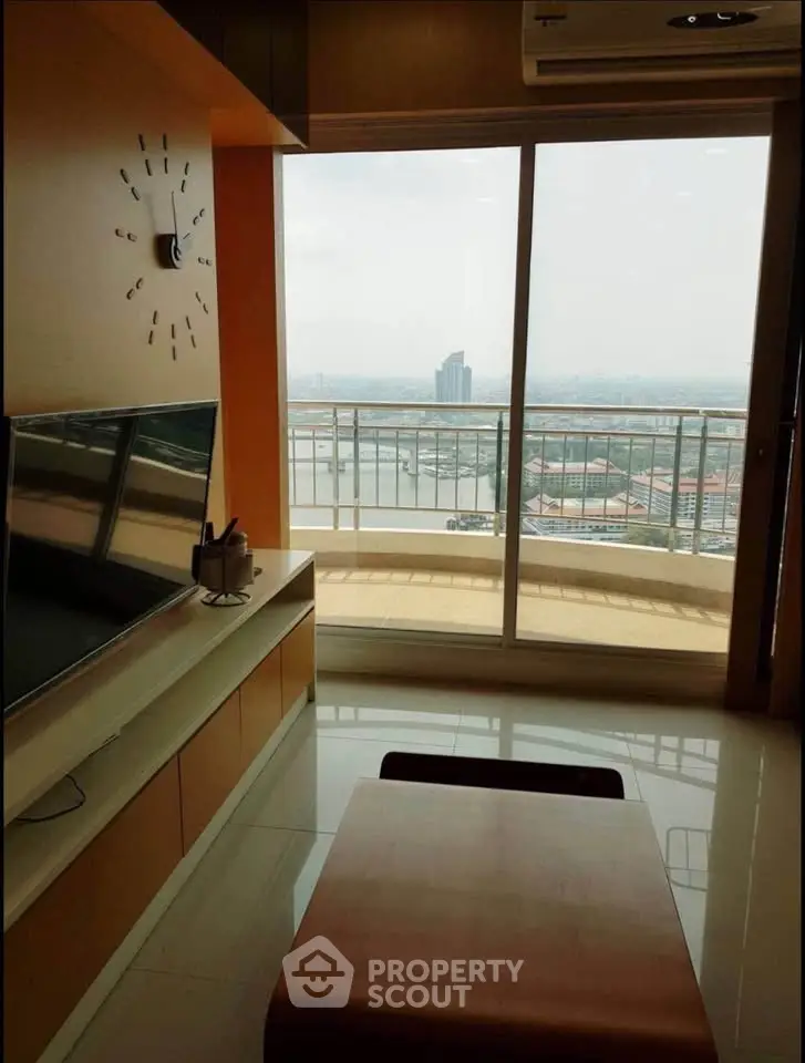 Modern living room with large window offering stunning city and river view, sleek furniture, and natural light.