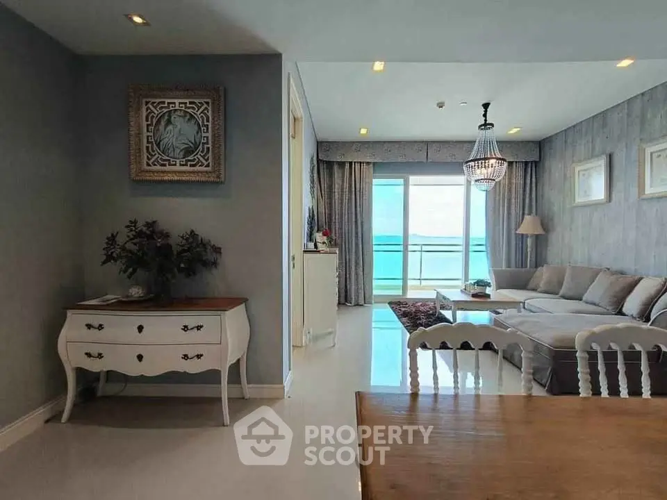 Luxurious living room with elegant decor and stunning sea view balcony.