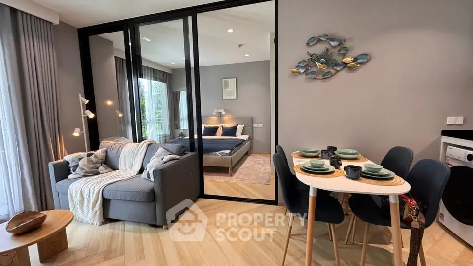 Stylish modern living room with cozy sofa and elegant dining area in open layout apartment.