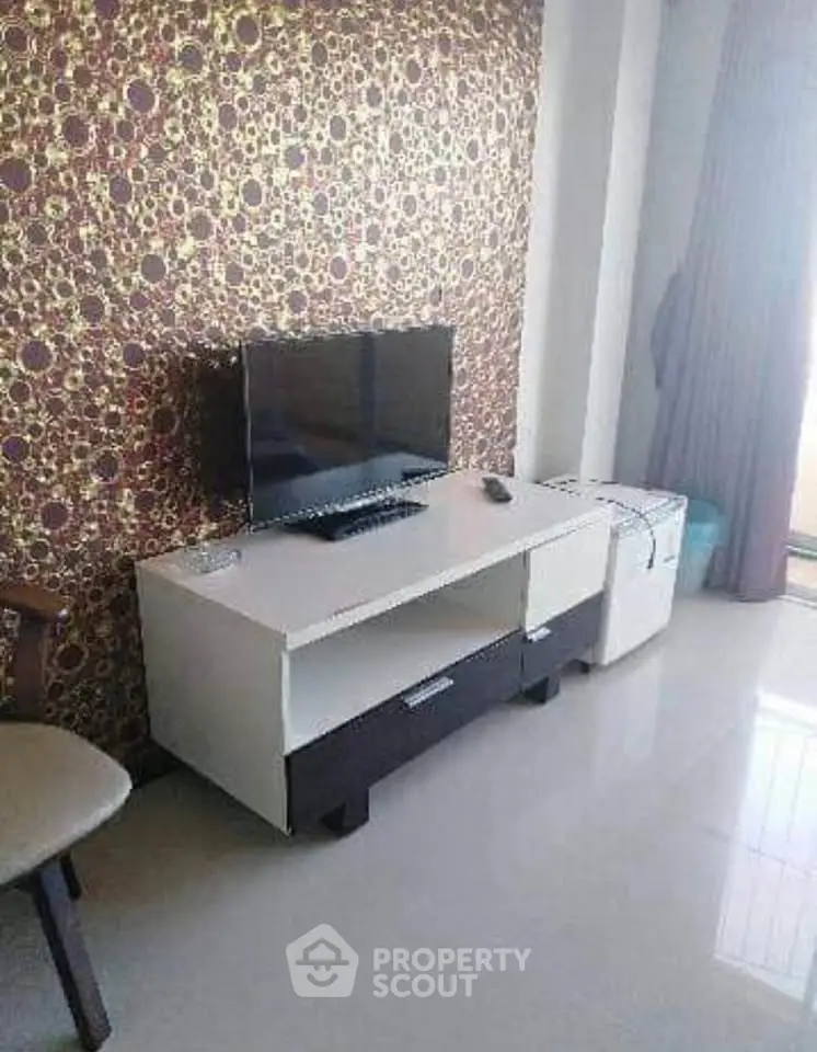 Modern living room with stylish TV stand and patterned wallpaper, perfect for cozy entertainment.