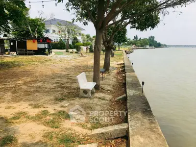 Charming riverside property with lush greenery and serene water views, perfect for tranquil living.