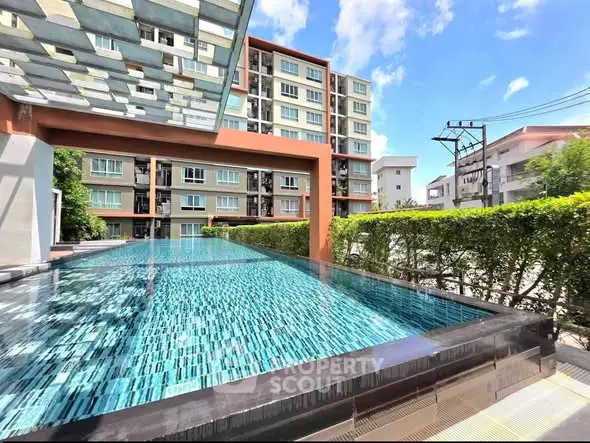 Luxurious apartment complex with stunning outdoor pool and modern architecture.