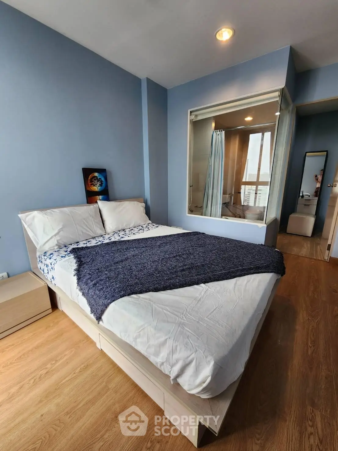 Cozy bedroom with modern decor and large window for natural light