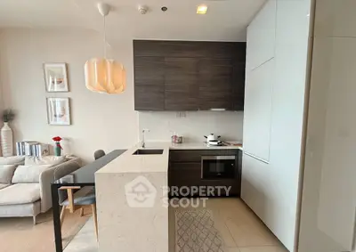 Modern open-layout kitchen with sleek design and cozy living area, perfect for urban living.