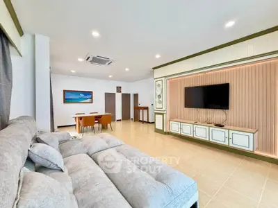 Spacious modern living room with elegant decor and large sofa, perfect for relaxation and entertainment.
