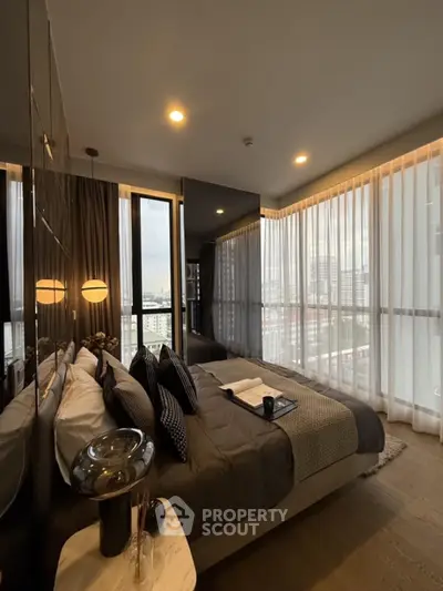 Luxurious bedroom with floor-to-ceiling windows and modern decor in high-rise apartment