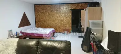 Spacious bedroom with unique wall design and cozy furnishings