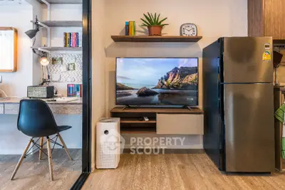 Modern living room with TV, fridge, and stylish workspace