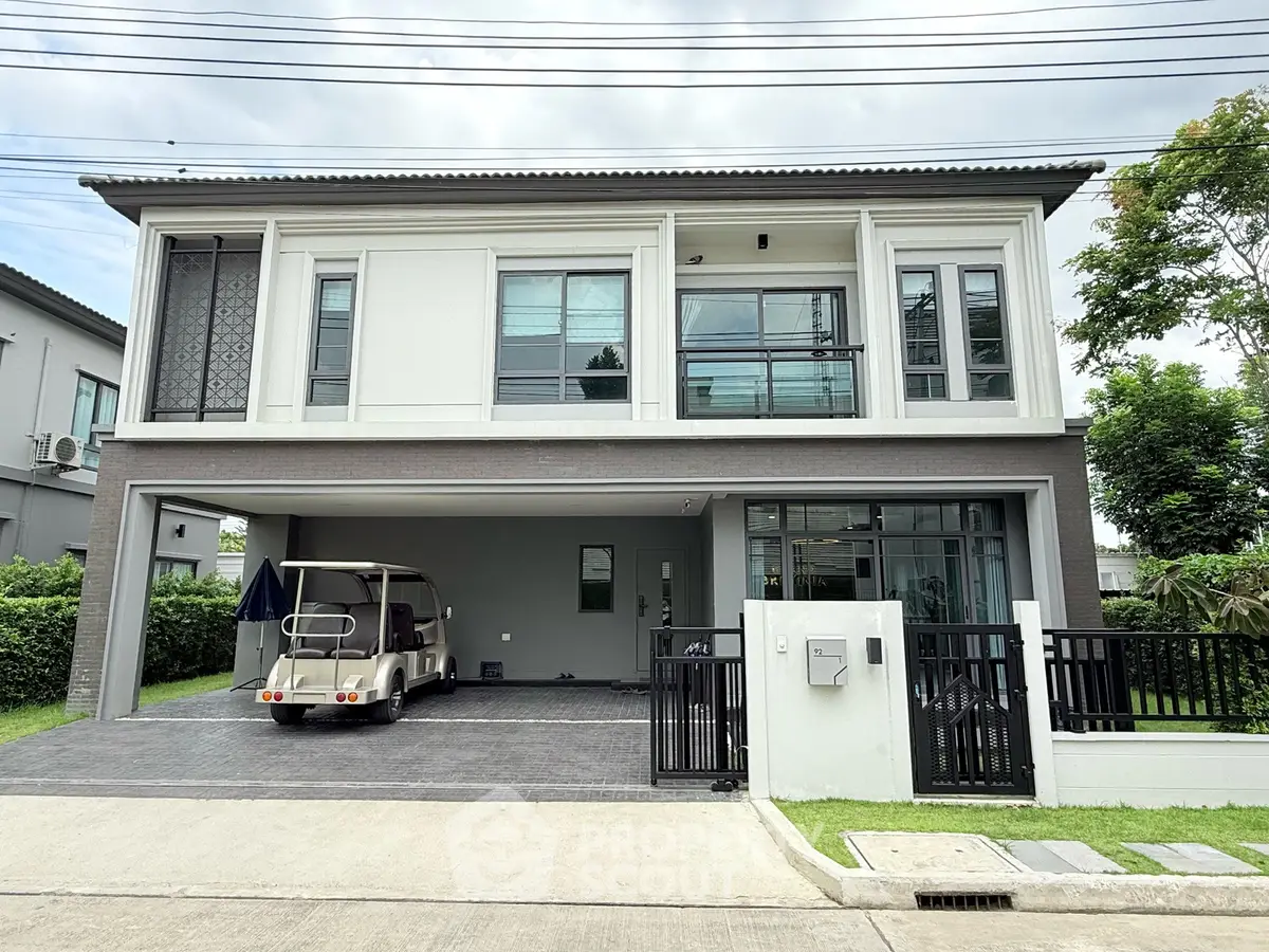 Modern two-story house with spacious garage and sleek exterior design in a suburban neighborhood.