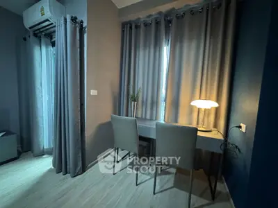 Modern study area with sleek desk, chairs, and ambient lighting