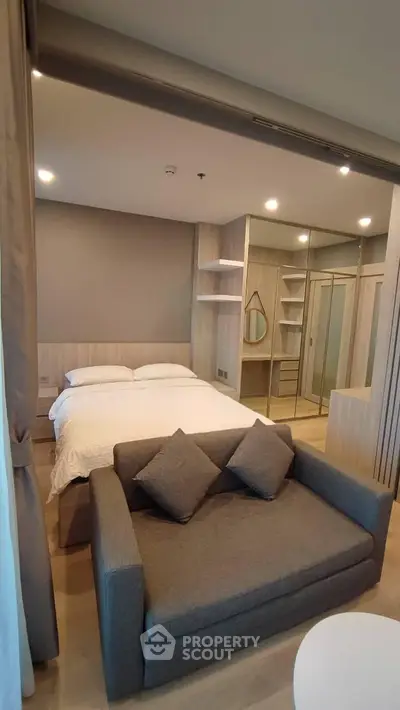 Modern studio apartment with cozy bed and stylish sofa in open layout