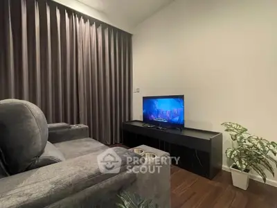 Cozy living room with plush seating and modern TV setup, perfect for relaxation.