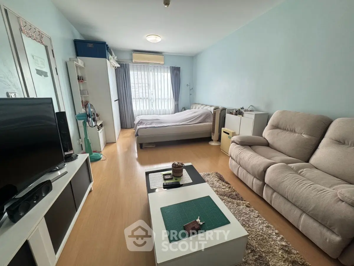 Spacious studio apartment with cozy living area and natural light