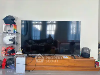 Modern living room with large flat-screen TV and stylish decor