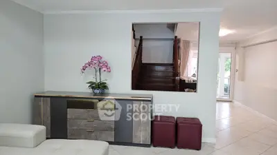 Spacious living room with elegant staircase and modern decor