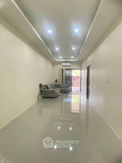 Spacious modern living room with sleek design and ample natural light