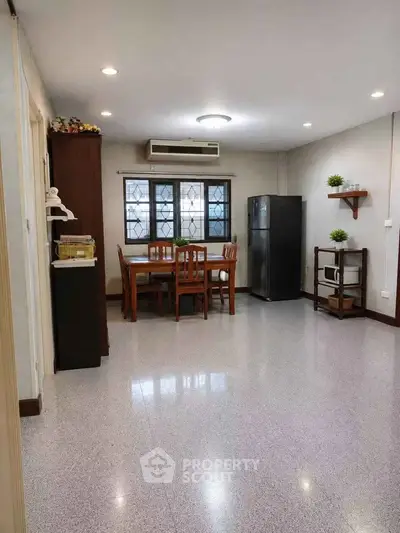Spacious dining area with modern appliances and natural light, perfect for family gatherings.