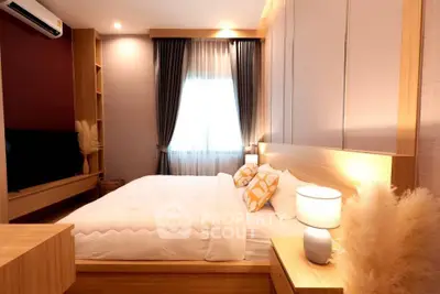 Cozy modern bedroom with stylish decor and warm lighting