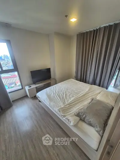 Modern bedroom with city view, featuring sleek design and cozy ambiance.