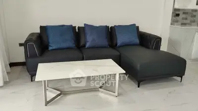 Modern living room with sleek black sofa and elegant marble coffee table