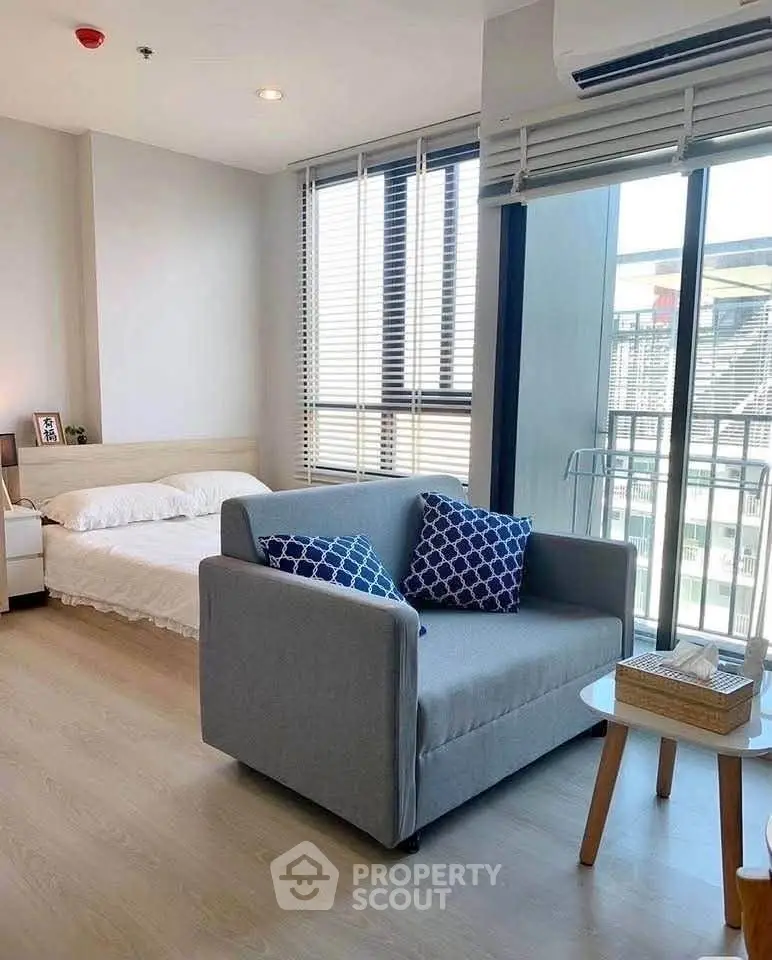 Modern studio apartment with cozy living area and natural light