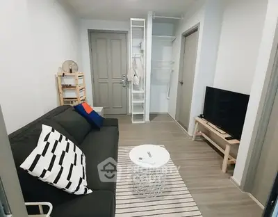 Modern living room with sleek furniture and open closet design.