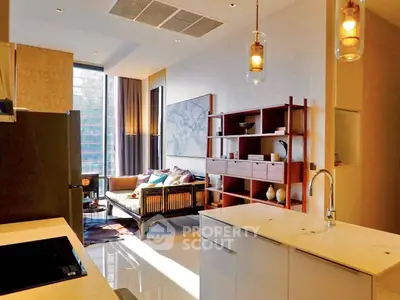 Modern open-layout kitchen and living room with stylish decor and natural light