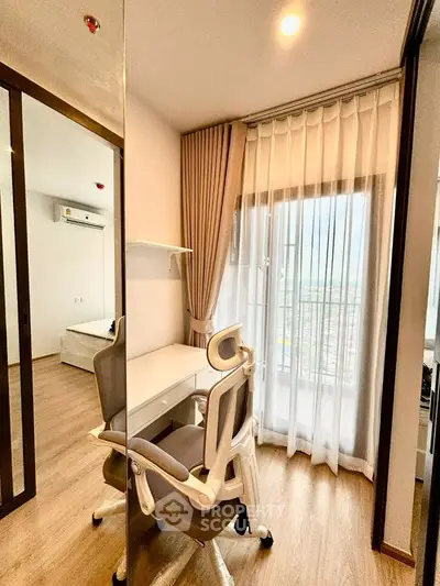 Modern study area with ergonomic chair and large window in a stylish apartment.