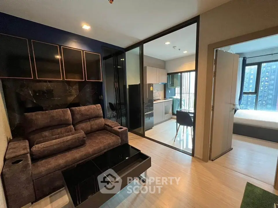 Modern apartment interior with open layout, featuring living room, kitchen, and bedroom.