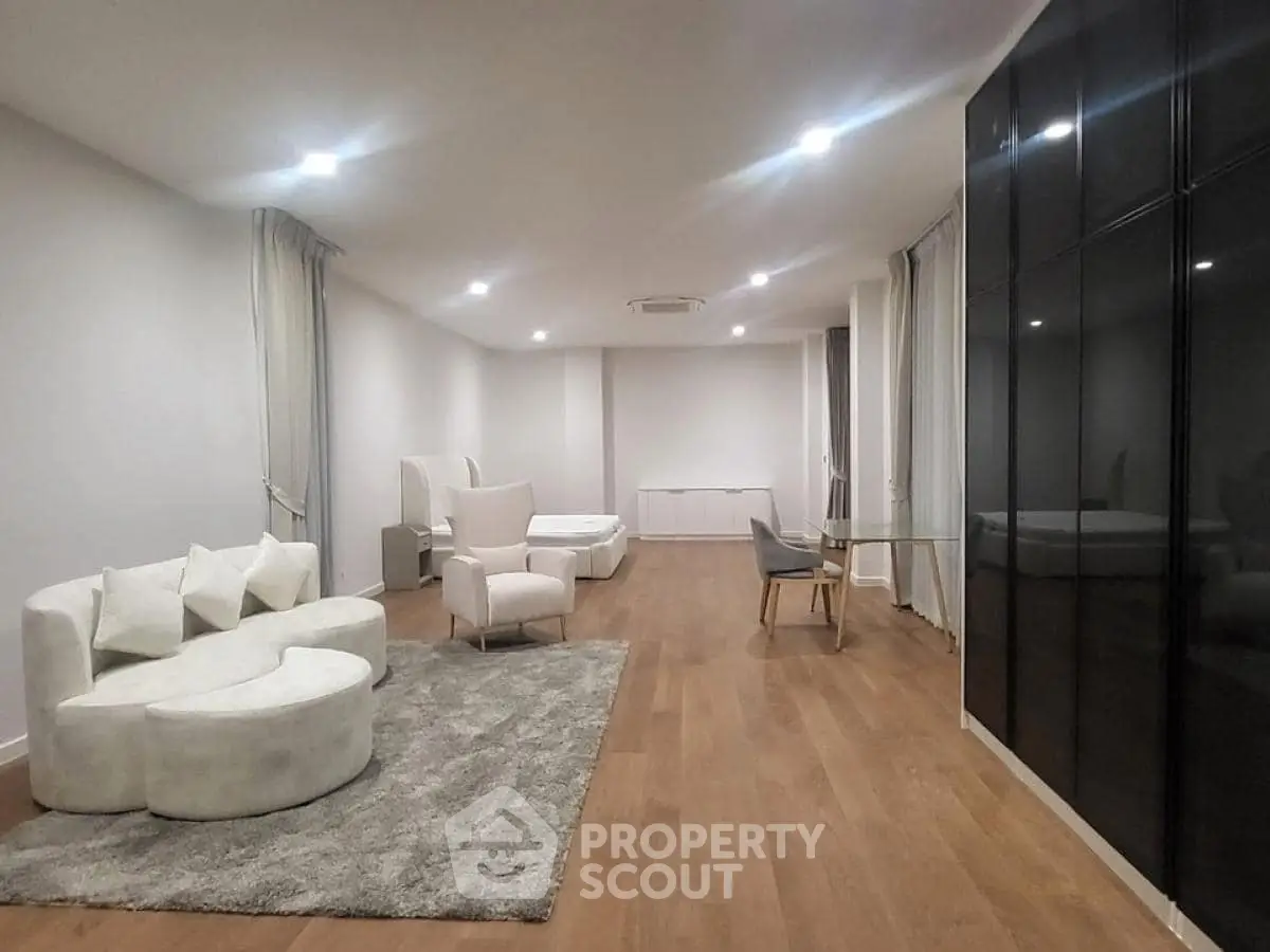Spacious modern living room with elegant furniture and wooden flooring
