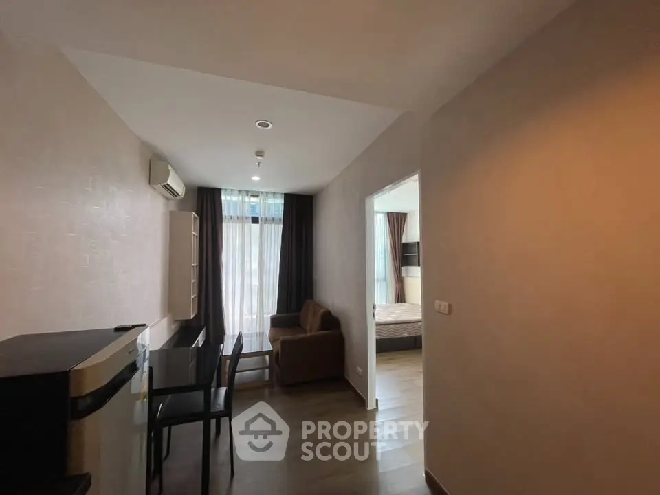 Modern apartment interior with cozy living area and bedroom view