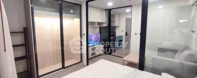 Modern studio apartment with sleek glass partitions and built-in storage