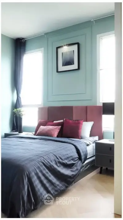 Modern bedroom with stylish decor and large windows for natural light.