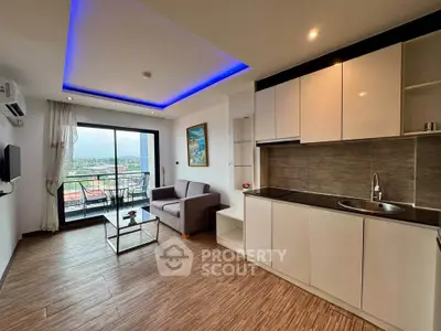 Modern open-layout living room with kitchen and balcony view, featuring sleek design and ambient lighting.