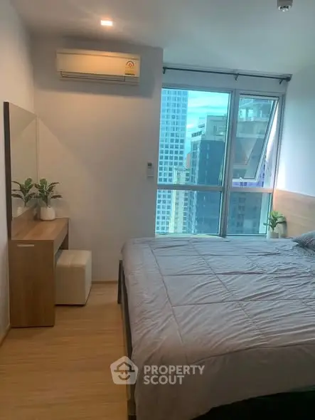 Modern bedroom with city view and air conditioning in high-rise apartment
