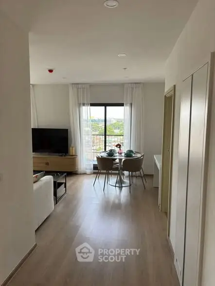 Modern living room with dining area and large window view
