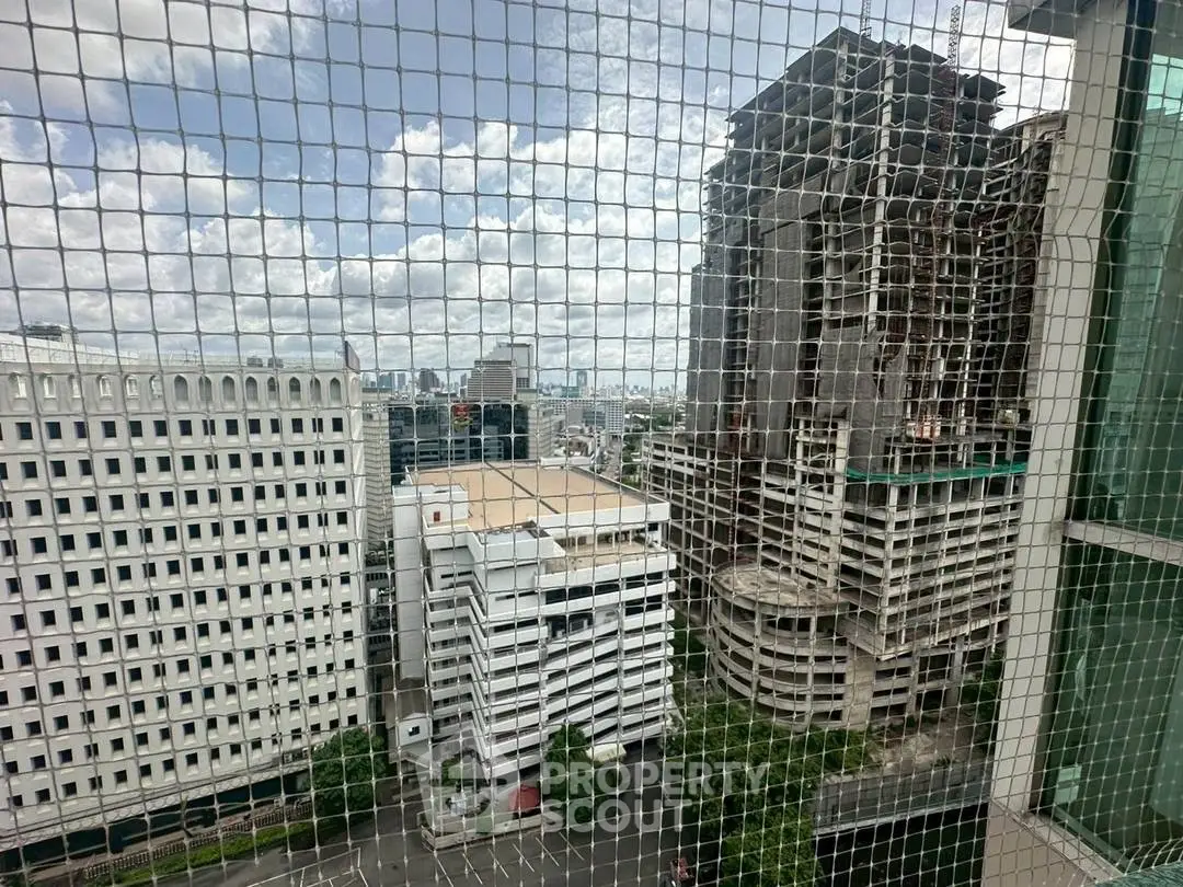 Stunning cityscape view from high-rise building with urban skyline and construction site.